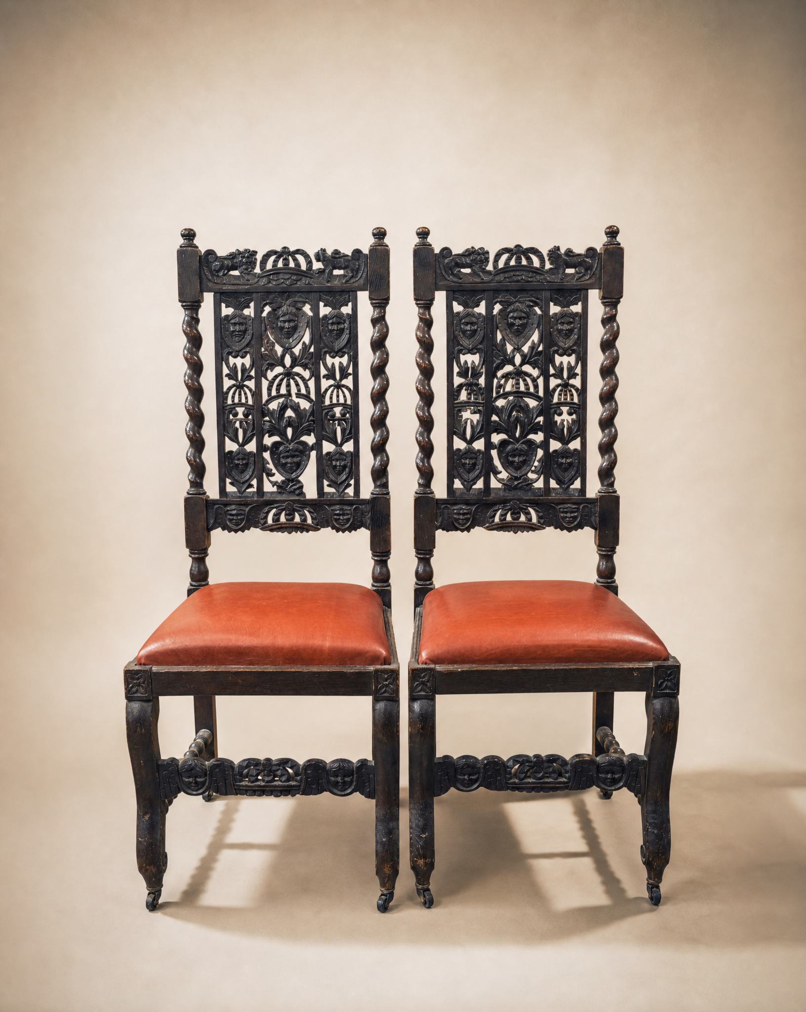 Pair of Antique Jacobean Revival Carved Oak Hall Chairs with Heraldic Crest Backs & Leather Seats