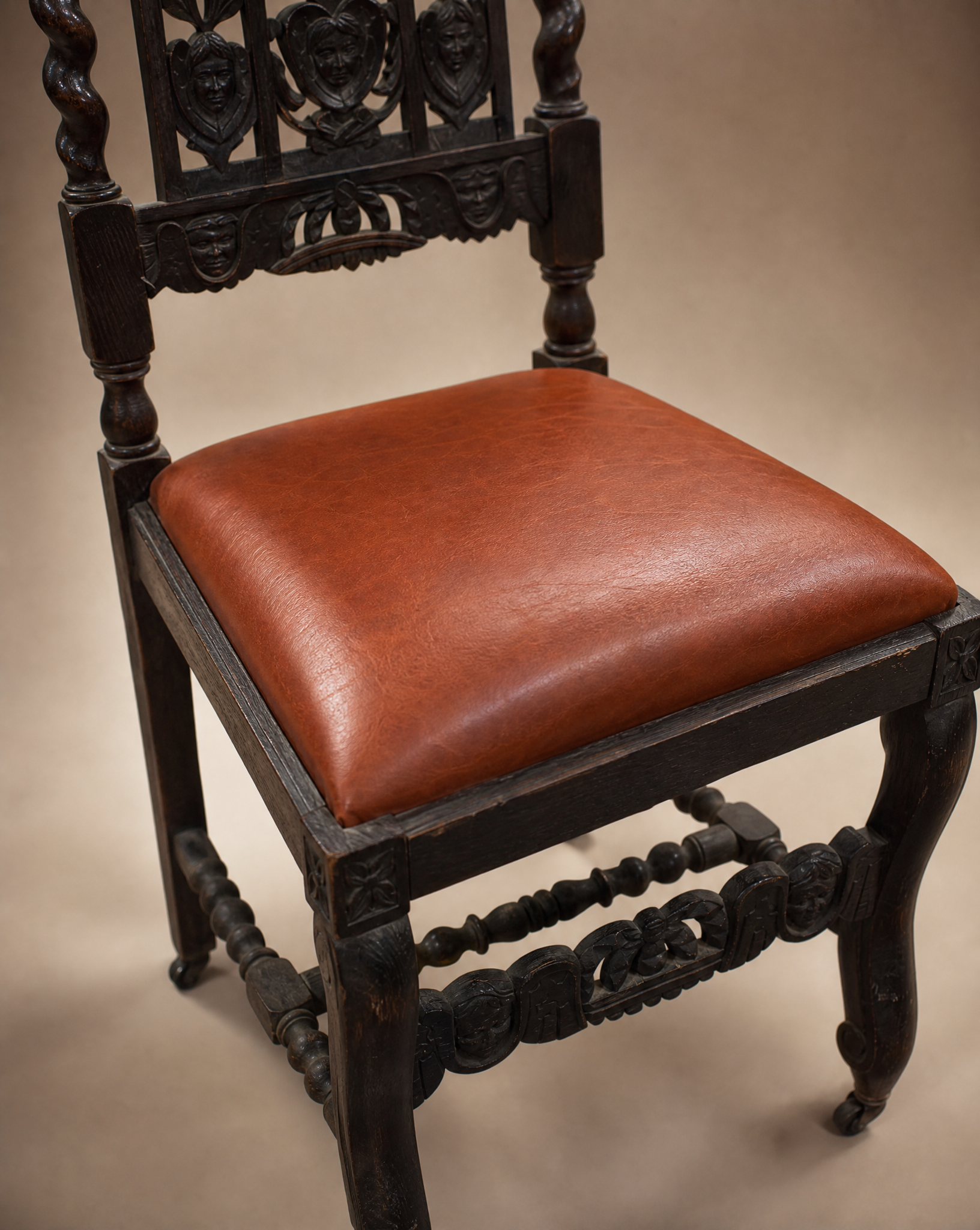 Pair of Antique Jacobean Revival Carved Oak Hall Chairs with Heraldic Crest Backs & Leather Seats